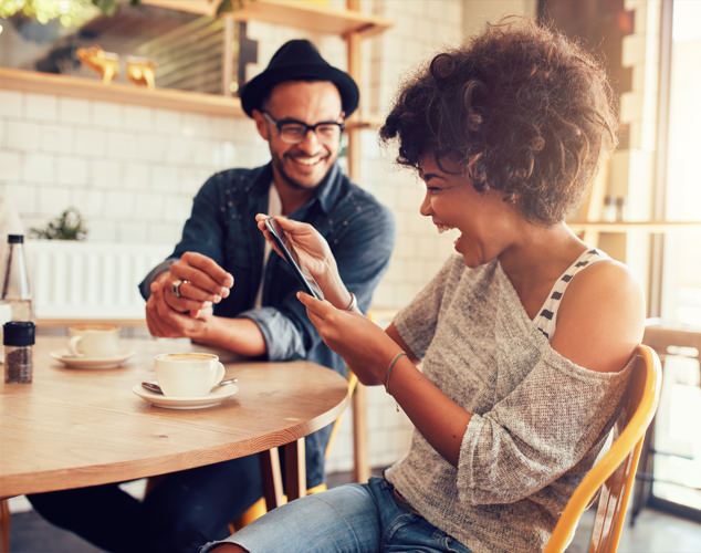 Man and woman looking at mobile device
