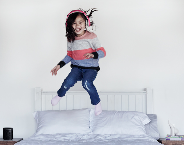 Child jumping on bed