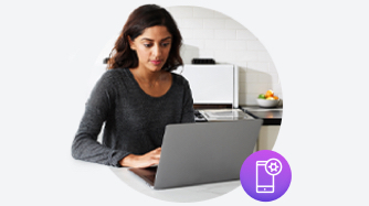 Woman typing on laptop with purple mobile icon on bottom right