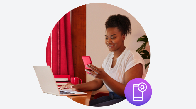 woman using laptop and mobile phone