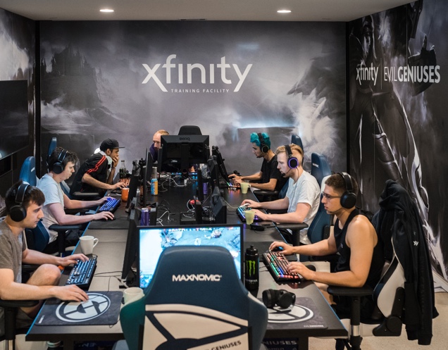 multiple people sitting at a table playing video games