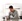 Man at kitchen counter looking at his phone